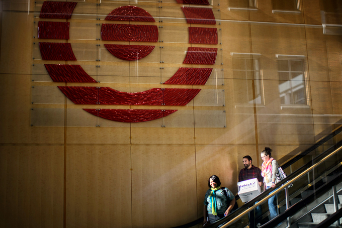 People leave Target's downtown Minneapolis corporate headquarters Tuesday, March 10, 2015. Target Corp. said Tuesday it is laying off 1,700 workers and eliminating another 1,400 unfilled positions as part of a restructuring aimed at saving $2 billion over the next two years. (AP Photo/Star Tribune, Glen Stubbe)