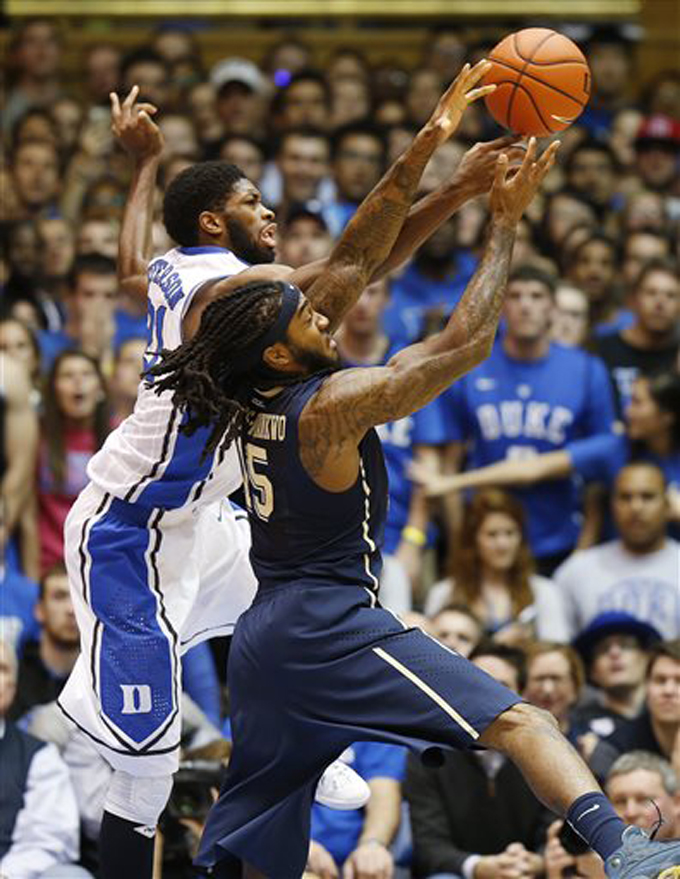 In this Jan. 19, 2015, file photo, Duke's Amile Jefferson, left, battles Pittsburgh's Aron Phillips-Nwankwo for the ball during the first half of an NCAA college basketball game in Durham, N.C. Phillips-Nwankwo has last five years living a double life at Pittsburgh. On the basketball court the 6-foot-7 forward is an end of the bench academic walk-on whose biggest impact is made in practice. In the classroom he's a budding superstar who overcame the loss of his mother and a crisis of confidence to emerge with two degrees and an eye toward medical school. (AP Photo/Ellen Ozier, File)