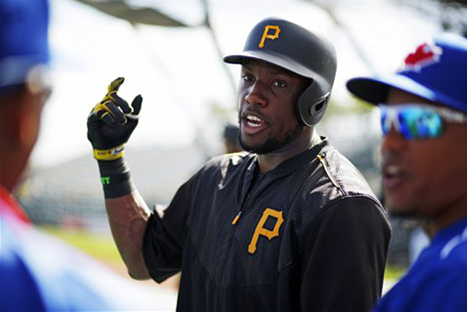 Pittsburgh Pirates' Starling Marte, center, visits with Toronto Blue Jays players before a spring training exhibition baseball game in Bradenton, Fla., Wednesday, March 4, 2015. (AP Photo/Gene J. Puskar)