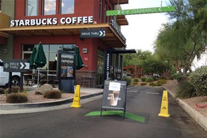 A Starbucks store closes Friday, April 24, 2015, in Phoenix because of computer issues. Starbucks says a sales register computer glitch has disrupted sales at company-operated stores in the United States and Canada. The company apologized to customers for the inconvenience late Friday and said it was working to resolve the outage. Customers found some stores closed and others offering free coffee. (AP Photo/Traci Carl)