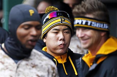 Wearing headgear reflecting the cool temperatures, Pittsburgh Pirates\' Gregory Polanco, left, Jung Ho Kang, center, of South Korea, and A.J. Burnett celebrate a solo-home run by Pirates' Sean Rodriguez in the second inning of a baseball game against the Chicago Cubs in Pittsburgh, Thursday, April 23, 2015. (AP Photo/Gene J. Puskar)