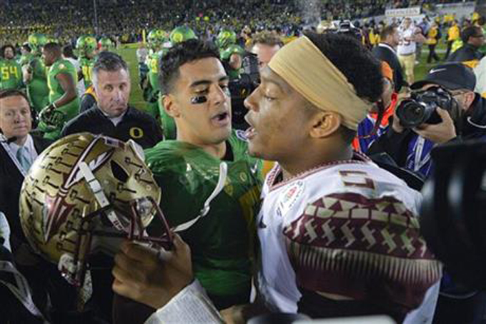 In this Jan. 1, 2015, file photo, Oregon quarterback Marcus Mariota, center left, greets Florida State quarterback Jameis Winston after Oregon\'s win in the Rose Bowl NCAA college football playoff semifinal game in Pasadena, Calif. There will be several noticeable absences when the three-day draft starts Thursday night, including potential top picks. Winston, Mariota and Alabama wide receiver Amari Cooper all plan to skip the spotlight. (AP Photo/Mark J. Terrill, File)