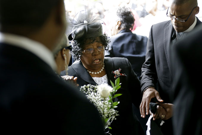 Judy Scott is escorted in for the funeral of her son, Walter Scott, at W.O.R.D. Ministries Christian Center, Saturday, April 11, 2015, in Summerville, S.C. Scott was killed by a North Charleston police officer after a traffic Saturday, April 4, 2015. The officer, Michael Thomas Slager, has been charged with murder. (AP Photo/David Goldman, Pool)