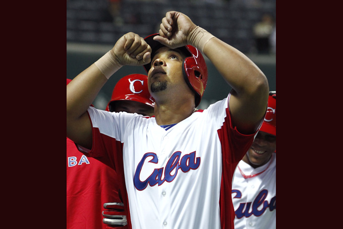 In this March 4, 2013, file photo, Cuba's first baseman Jose Abreu celebrates after hitting a grand slam off China's Liu Yu in the fifth inning of their World Baseball Classic first-round game in Fukuoka, Japan. (AP Photo/Koji Sasahara, File)