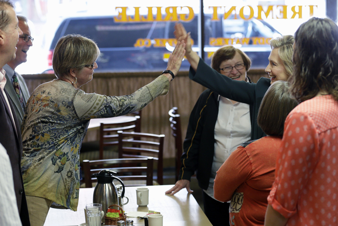 In this April 15, 2015, photo, Democratic presidential candidate Hillary Rodham Clinton, second from right, visits with local residents at The Tremont in Marshalltown, Iowa. T(AP Photo/Charlie Neibergall)