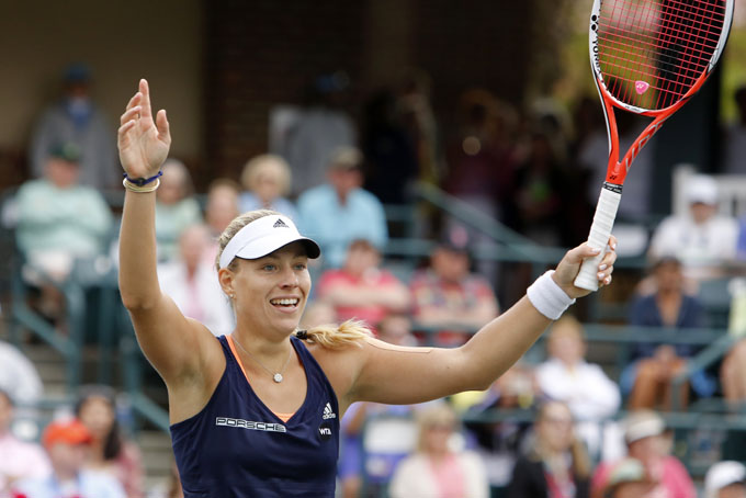Angelique Kerber, from Germany, celebrates defeating Madison Keys during singles final action at the Family Circle Cup tennis tournament in Charleston, S.C., Sunday, April 12, 2015. Kerber won the Family Circle Cup by beating Keys 6-2, 4-6, 7-5. (AP Photo/Mic Smith)