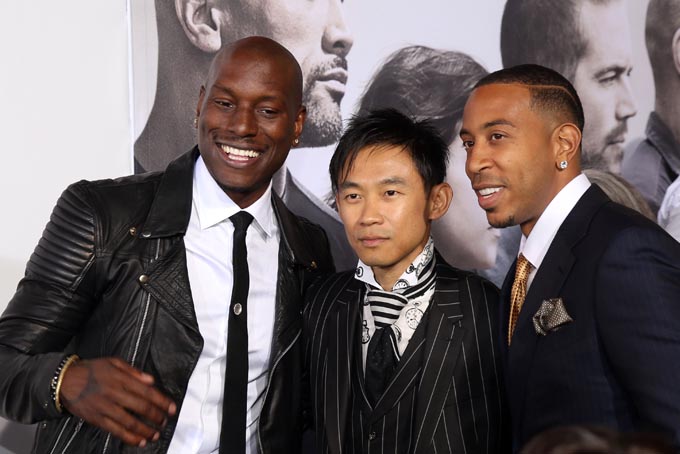 In this Wed., April 1, 2015 file photo, James Wan, center, Tyrese Gibson, left, and Ludacris arrive at the premiere of "Furious 7" at the TCL Chinese Theatre IMAX, in Los Angeles. Featuring multicultural casts and international settings, the franchise has continued for 14 years and generated $2.4 billion in global earnings. Wan, director of the latest installment, “Furious 7,” said keeping casts diverse is “almost like a no-brainer.” (Photo by Matt Sayles/Invision/AP, File)