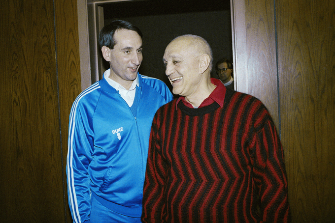 In this April 1, 1990, file photo, Duke University head coach Mike Krzyzewksi and UNLV head coach Jerry Tarkanian meet in passing between press conferences for the NCAA Championship game in Denver. A year later, UNLV, led by Tarkanian, arrived in Indianapolis needing two wins to become the first undefeated national champion since Indiana in 1976. Kentucky faces Wisconsin Saturday, April 4, 2015, in the national semifinals in Indianapolis. That was the round in which UNLV's undefeated dreams were dashed by Duke. (AP Photo/Ed Reinke, File)