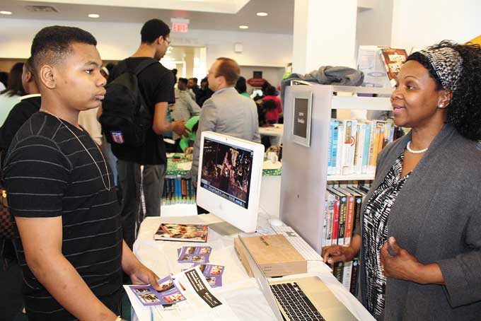 INTERESTED IN THE ARTS—Akelay Green from Friendship Academy speaking to Sylvia Wallace, president and CEO of the non-profit organization Dynasty Arts, about job opportunities in the arts.