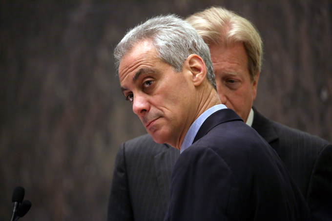 Chicago Mayor Rahm Emanuel, left, with corporation counsel Steve Patton by his side, presides over the Chicago City Council for the first time after being re-elected mayor, Wednesday, April 15, 2015, in Chicago. The Chicago City Council has approved a $5 million settlement with the family of a teenager who died after being shot by a police officer 16 times last October. (Nancy Stone/Chicago Tribune via AP) 