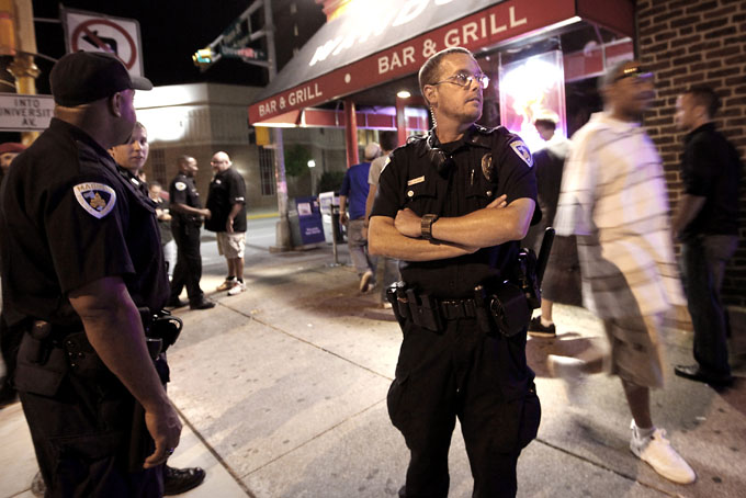 In this April 28, 2012 photo, Madison Police Officer Matthew Kenny, right, patrols a night club area on the University of Wisconsin campus in Madison. District Attorney Ismael Ozanne is weighing whether to file charges against Kenny in the shooting death of Tony Robinson. Kenny, who is white, shot Robinson, who was biracial, on March 6. (AP Photo/Wisconsin State Journal, John Hart)