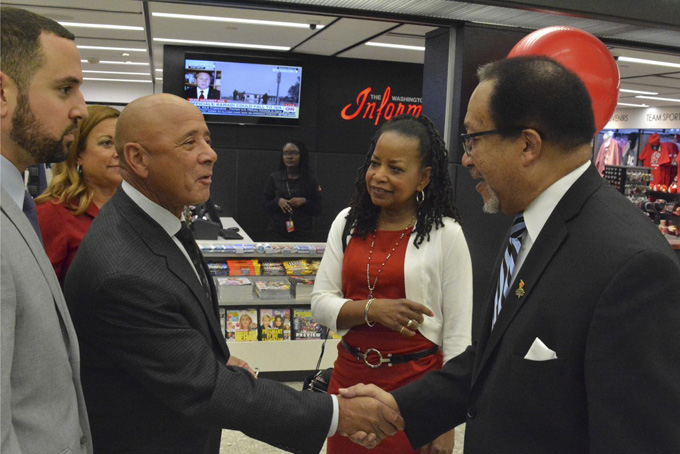 Denise Rolark Barnes (center), the publisher of the Washington Informer, introduces Robert B. Crews (left), the president and CEO of Crews 1972 to Dr. Benjamin F. Chavis, Jr., the president and CEO of the National Newspaper Publishers Association, at the opening of the Washington Informer Store at Washington Dulles International Airport. (Roy Lewis/Washington Informer).