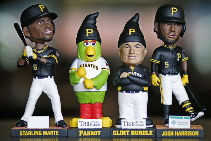 These are Pittsburgh Pirates 2015 promotional bobble heads and statues displayed during a media open house at PNC Park, Thursday, Apr. 9, 2015, in Pittsburgh. Featured are from left, a bobble head of left fielder Starling Marte, a gnome statue of the Pirates mascot the Pirate Parrott, a gnome statue of  manager Clint Hurdle, and a bobble head of third baseman Josh Harrison. The Pirates home opener will be Monday, Apr. 13, 2015, against the Detroit Tigers. (AP Photo/Gene J. Puskar)