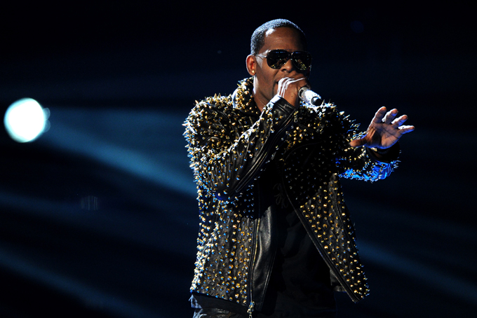 In this June 30, 2013 file photo, R. Kelly performs onstage at the BET Awards at the Nokia Theatre  in Los Angeles. The owners of 5001 Flavors knew when they started the company 23 years ago they wanted to sell custom-made clothes to rap and R&B musicians. They sought out artists and record company executives at parties and music industry events. They looked in particular for up-and-coming artists. Now musicians like R. Kelly and Kid Rock are among their fans. (Photo by Frank Micelotta/Invision/AP)