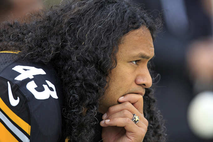 In this Oct. 7, 2012, file photo, Pittsburgh Steelers strong safety Troy Polamalu sits on the bench during an NFL football game against the Philadelphia Eagles in Pittsburgh. Polamalu's iconic football career is over. The eight-time Pro Bowl safety told the Uniontown Herald-Standard he informed Steelers chairman Dan Rooney on Thursday night, April 9, 2015, he will retire rather than return for a 13th season. (AP Photo/Gene J. Puskar, File)