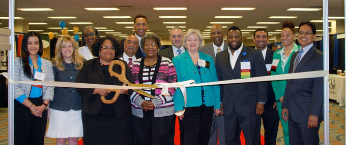 THIRTY NINE AND COUNTING—EMSDC Chief Executive Officer, Valarie J. Cofield and Chief Operating Officer; Alexander Nicholas fourth from the left in the back row kick off their annual event with a ribbon cutting ceremony with board members at their side. (Photos by Diane I. Daniels)