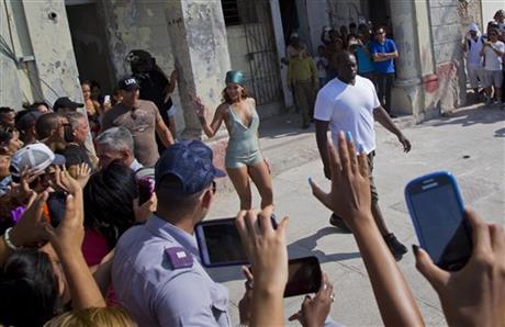Pop artist Rihanna waves at fans as she leaves a building on the Malecon, after a photo shoot with photographer Annie Leibovitz, in Havana, Cuba, Friday, May 29, 2015. (AP Photo/Desmond Boylan)