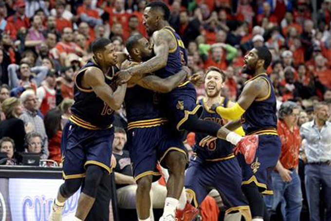 In this May 10, 2015, file photo, Cleveland Cavaliers' LeBron James, second from left, hugs teammate J.R. Smith, as they celebrate beating the Chicago Bulls in Game 4 of the conference semifinals in the NBA playoffs in Chicago. From left are Tristan Thompson, James, Smith, Matthew Dellavedova, and Kyrie Irving, right. J.R. Smith, the enigmatic shooting guard, who came to the Cavaliers with the reputation of being diffcult, has found a new home in Cleveland and he's relishing the chance to be part of a team moving toward an NBA title. (AP Photo/Nam Y. Huh, File)