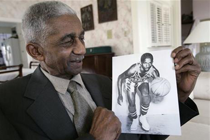 In this Feb. 14, 2008, file photo, former Harlem Globetrotters great Marques Haynes holds a photo circa 1951 of himself in his Globetrotters uniform, in Plano, Texas. Haynes died Friday, May 22, 2015, in Plano, Texas. He was 89. (AP Photo/Tony Gutierrez, File)