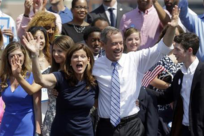 Former Maryland Gov. Martin O'Malley, right, and his wife Katie wave to supporters during an event to announce that he is entering the Democratic presidential race, Saturday, May 30, 2015, in Baltimore. O'Malley joined the Democratic presidential race with a longshot challenge to Hillary Rodham Clinton for the 2016 nomination. "I'm running for you," he told a crowd of about 1,000 people at Federal Hill Park in Baltimore, where he served as mayor before two terms as governor. (AP Photo/Patrick Semansky)