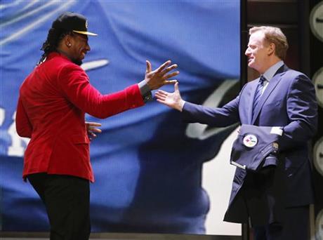  Kentucky linebacker Bud Dupree celebrates with NFL commissioner Roger Goodell after being selected by the Pittsburgh Steelers as the 22nd pick in the first round of the 2015 NFL Draft, Thursday, April 30, 2015, in Chicago. (AP Photo/Charles Rex Arbogast)