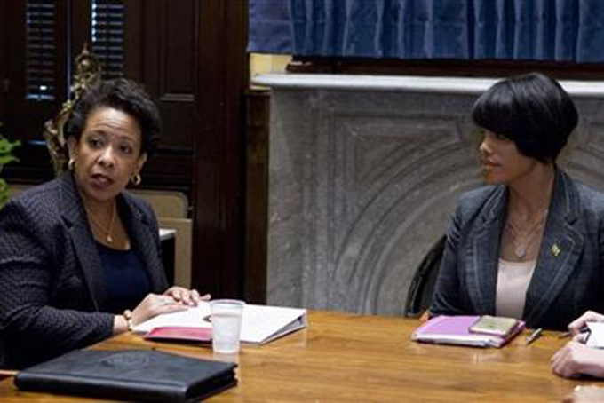 In this May 5, 2015 file photo, Attorney General Loretta Lynch, left, accompanied by Baltimore Mayor Stephanie Rawlings-Blake speaks during a work meeting at Baltimore City Hall in Baltimore. A few miles off in any direction, and the debate about the knife involved in Freddie Gray's arrest by Baltimore police may have been completely different. (AP Photo/Jose Luis Magana, File, Pool)