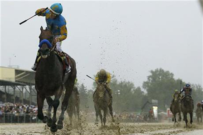 Jockey Victor Espinoza, left, celebrates aboard American Pharoah after winning the 140th Preakness Stakes horse race at Pimlico Race Course, Saturday, May 16, 2015, in Baltimore. (AP Photo/Matt Slocum)