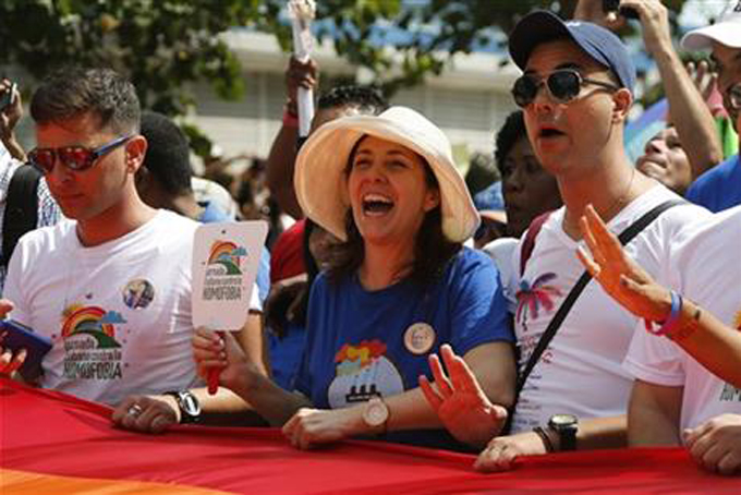 Mariela Castro, center, daughter of Cuba\'s President Raul Castro, takes part in a parade with Cuba\'s LGBT community in Havana, Cuba, Saturday, May 9, 2015. A day before Cuban President Raul Castro visits the Vatican, his daughter sponsored a blessing ceremony for gay couples on an island where gay marriage remains illegal. (AP Photo/Desmond Boylan) Mariela Castro, center, daughter of Cuba\'s President Raul Castro, takes part in a parade with Cuba\'s LGBT community in Havana, Cuba, Saturday, May 9, 2015. A day before Cuban President Raul Castro visits the Vatican, his daughter sponsored a blessing ceremony for gay couples on an island where gay marriage remains illegal. (AP Photo/Desmond Boylan)Rev. Roger LaRade, of the Eucharistic Catholic Church in Canada, blesses a gay couple as they lean in to kiss each other in Havana, Cuba, Saturday, May 9, 2015. The blessing ceremony for gay couples was part of official ceremonies leading up to the Global Day against Homophobia on May 17. (AP Photo/Desmond Boylan)Rev. Roger LaRade, of the Eucharistic Catholic Church in Canada, carries a gay pride flag before giving blessings to couples from the LGBT community in Havana, Cuba, Saturday, May 9, 2015. The blessing ceremony on an island where gay marriage remains illegal was part of official ceremonies leading up to the Global Day against Homophobia on May 17. (AP Photo/Desmond Boylan)Members of Cuba's LGBT community take part in a gay pride parade in Havana, Cuba, Saturday, May 9, 2015. The parade is part of official ceremonies leading up to the Global Day against Homophobia on May 17. (AP Photo/Desmond Boylan)A member of Cuba's LGBT community smiles for the camera after a gay pride parade in Havana, Cuba, Saturday, May 9, 2015. The event is part of official ceremonies leading up to the Global Day against Homophobia on May 17. (AP Photo/Desmond Boylan)Members of Cuba's LGBT community take part in a gay pride parade in Havana, Cuba, Saturday, May 9, 2015. The event is part of official ceremonies leading up to the Global Day against Homophobia on May 17. (AP Photo/Desmond Boylan)