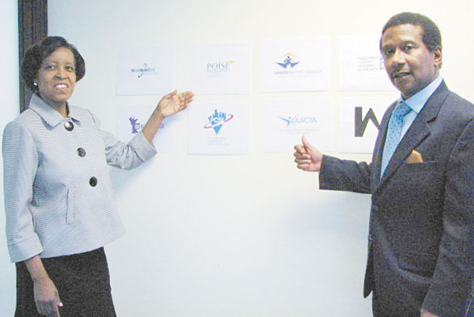 A PERFECT TEAM—Kathy and Russell Bynum, the owners of Bynums Marketing and Communications, Inc. display a few of their clients logos. (Photos by Diane I. Daniels)  