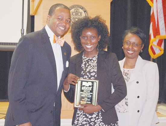 CLARECE POLKE, a first place winner from the Pittsburgh Post Gazette, center, stands with PBMF Vice President Brian Cook and PBMF President Tory N. Parrish. 