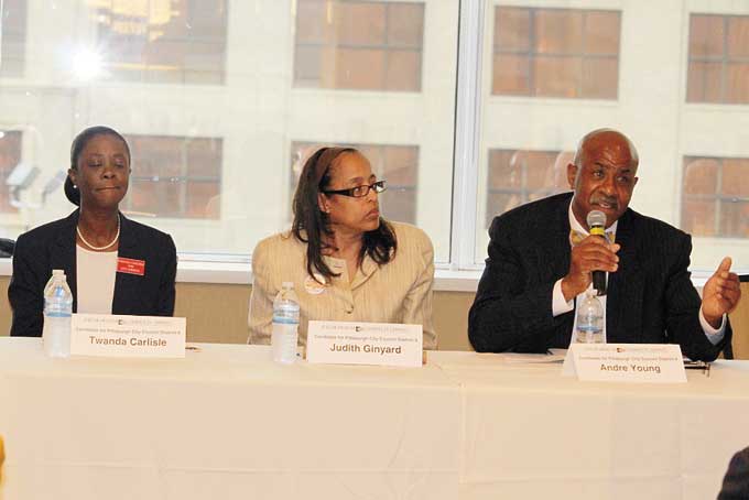 FACING THE MUSIC—District 9 Pittsburgh Council hopeful Andre Young speaks during the African American Chamber’s Candidate Forum as rivals, l-r, Twanda Carlisle and Judy Ginyard look on. (Photo by J.L. Martello)