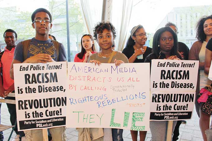 YOUTH PROTEST FREDDIE GRAY’S DEATH—L-R, David Wise, 18, from the Hill District; Hailee Roye, 17, from Stanton Heights; and Darrien Hopkins, 16, from McKees Rocks hold their signs in support of the Oakland rally held for Freddie Gray. (Photos by J.L. Martello).  