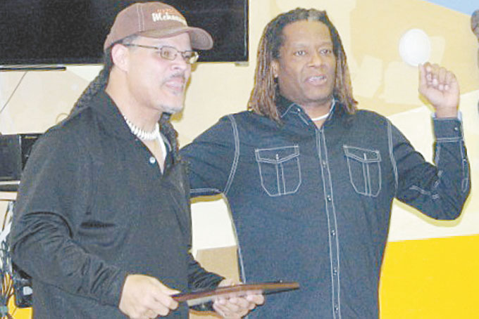 JOB WELL DONE—Keith Murphy, owner of the Healthy Village Institute for Learning Community Center accepts his award from program organizer Juan Garrett of the Riverside Center for Innovation. (Photos by Diane I. Daniels) 