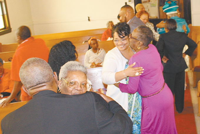 LOVE GREETINGS—Members of the church greeting each other and guests during the service.