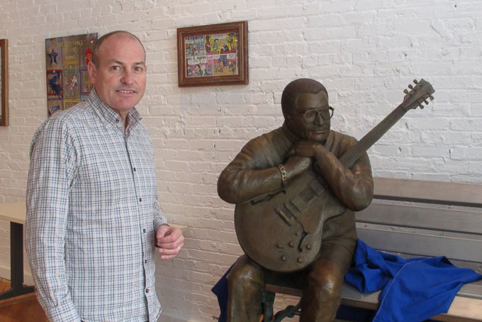 This April 14, 2015 photo shows Jay Sieleman, president and CEO of The Blues Foundation, next to a statue of blues musician Little Milton at the Blues Hall of Fame museum in Memphis, Tenn. The foundation raised nearly $3 million for the museum, which is set to open Friday, May 8, in Memphis. (AP Photo/Adrian Sainz) 