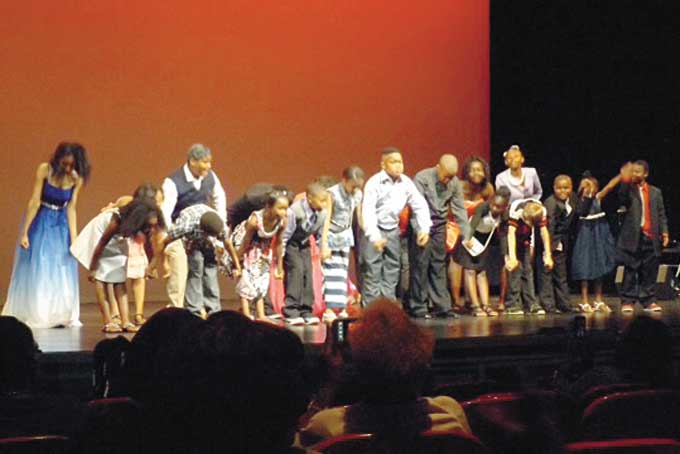VIRTUOUS ACADEMY CAST—Top photo left: Gathered around father: from left: Naomi Greene, Nathaniel Jenkins, NaTaiya Pace, Malik Greene, Alexis Spencer, and Deanteshalei Boyd.  Top photo right: Beauty and her beast Devan Crenshaw and NaTaiya Pace. Bottom photo: taking a bow...Virtuous Academy students. (Photos by Nikki Coffee) 