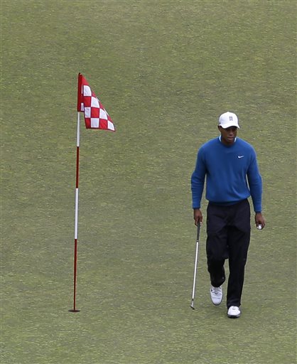 Tiger Woods walks past the flag as he practices on the ninth green, Tuesday, June 2, 2015, at Chambers Bay in University Place, Wash., where the U.S. Open will be played June 18-21. (AP Photo/Ted S. Warren)