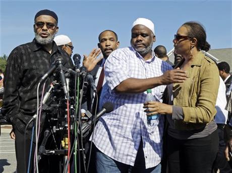 Ibrahim Rahim, second from right, brother of shooting victim Usaama Rahim, reacts with a relative during a news conference Thursday, June 4, 2015, in Boston's Roslindale neighborhood in the area where Rahim was shot to death. Police said Usaama Rahim had lunged at members of the Joint Terrorism Task Force with a knife when they approached to question him. (AP Photo/Elise Amendola)