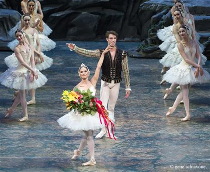 This photo provided by American Ballet Theater, Misty Copeland and James Whiteside acknowledge the audience after appearing in "Swan Lake" at the Metropolitan Opera House on June 24, 2015. It was Copeland's New York debut in the lead role, a key moment for her fans who hope she'll soon be named American Ballet Theater's first black principal dancer. (Gene Schiavone/American Ballet Theater via AP)