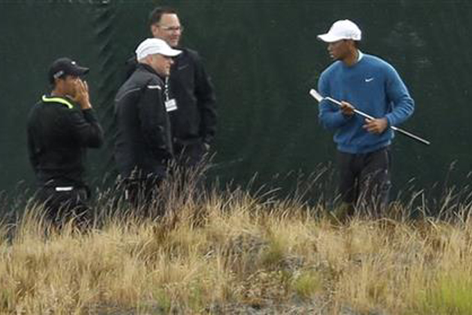 Tiger Woods walks past the flag as he practices on the ninth green, Tuesday, June 2, 2015, at Chambers Bay in University Place, Wash., where the U.S. Open will be played June 18-21. (AP Photo/Ted S. Warren)     Tiger Woods walks past the flag as he practices on the ninth green, Tuesday, June 2, 2015, at Chambers Bay in University Place, Wash., where the U.S. Open will be played June 18-21. (AP Photo/Ted S. Warren)