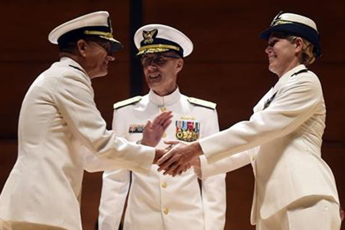 Incoming U.S. Coast Guard Academy superintendent Rear Adm. James E. Rendon, left, shakes hands with his predecessor; newly promoted U.S. Coast Guard Vice Admiral Sandra L. Stosz, right, as presiding officer Vice Adm. Peter Neffenger, center, offers he congratulations during a change of command ceremony, Monday, June 1, 2015 in Leamy Hall Auditorium. (Sean D. Elliot/The Day via AP)