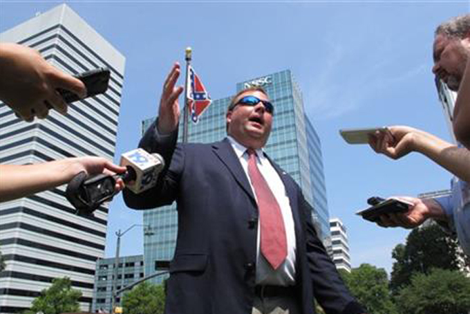 Sons of Confederate Veterans member Dickie Phalen speaks to reporters at the South Carolina Statehouse after a rally to support the Confederate flag on Thursday, June 25, 2015, in Columbia, S.C. (AP Photo/Jeffrey Collins)