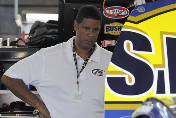 Brad Daugherty looks at his NASCAR car before practice for Coca-Cola 600 auto race at Charlotte Motor Speedway in May . (Photo: AP Photo/Mike McCarn)