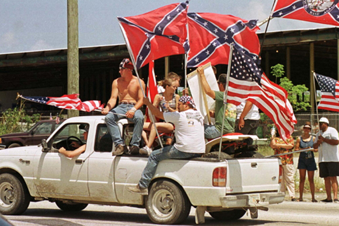 PROTESTERS SHOW CONFEDERATE AND US FLAGS AT PRO RENO RALLY.