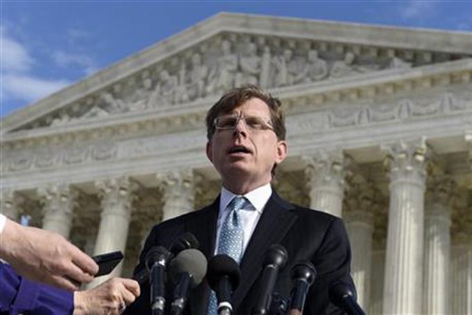 In this Dec. 1, 2014 file photo, John P. Elwood, attorney for Anthony D. Elonis, who claimed he was just kidding when he posted a series of graphically violent rap lyrics on Facebook about killing his estranged wife, shooting up a kindergarten class and attacking an FBI agent, speaks to reporters outside the Supreme Court in Washington.  (AP Photo/Susan Walsh)
