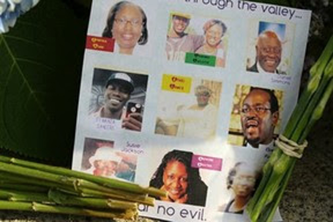 A note on the sidewalk includes photos of the nine who were killed at a memorial in front of the Emanuel AME Church on Friday, June 19, 2015 in Charleston, S.C. Dylann Storm Roof, 21, is accused of killing nine people during a Wednesday night Bible study at the church. ( Curtis Compton/Atlanta Journal-Constitution via AP) - See more at: https://www.afro.com/world-shocked-at-enduring-racism-gun-violence-in-us/?utm_source=Saturday+News+Wrap-up+E-Blast%2C+June+20%2C+2015&utm_campaign=sat+eblast&utm_medium=email#sthash.Pu2pK2PK.dpuf