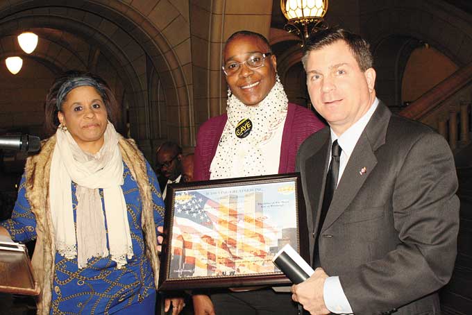 HONOREE AND CO-SPONSOR—Attorney William Caye, right, receives award from Achieving Greatness Inc.’s Administrative Director Lashon Jackson, left, and Marketing Director Elizabeth King.