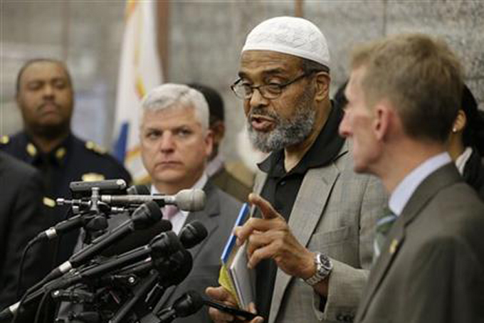 Abdullah Faaruuq, Imam of the Mosque for the Praising of Allah, in Boston, center right, speaks to reporters during a news conference as Suffolk County District Attorney Dan Conley, center left, and Boston Police Commissioner William Evans, right, look on during a news conference, Wednesday, June 3, 2015, at Boston Police Headquarters, in Boston. Boston police said they have video showing Usaama Rahim, a man who was under 24-hour surveillance by terrorism investigators, lunging with a knife at a police officer and an FBI agent before he was shot and killed. (AP Photo/Steven Senne)