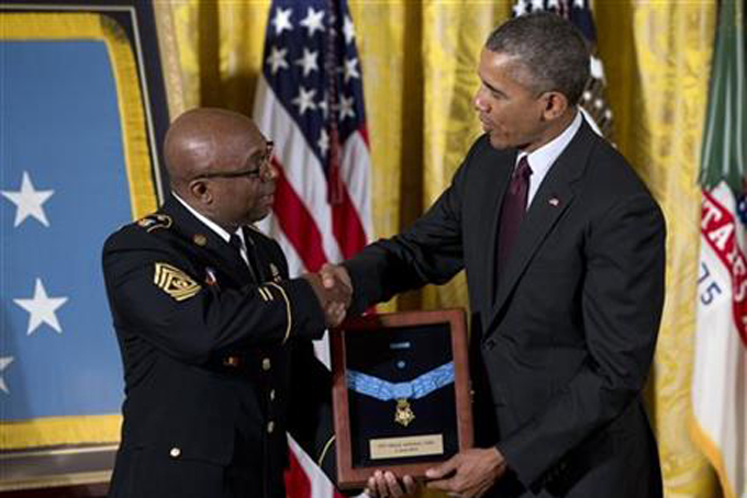 President Barack Obama posthumously bestows the Medal Of Honor for Army Pvt. Henry Johnson to New York National Guard Command Sgt. Maj. Louis Wilson during a ceremony in the East Room of the White House in Washington, Tuesday, June 2, 2015. (AP Photo/Carolyn Kaster)
