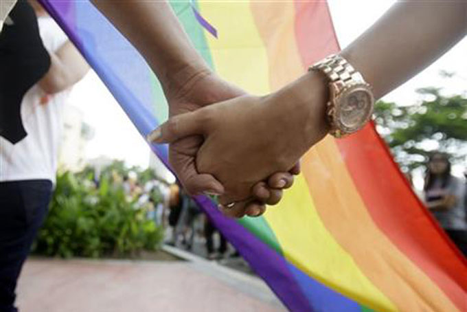 PRIDE CELEBRATION—Filipino LGBTs (Lesbians Gays Bisexual and Transgenders) hold hands as they gather for a Gay Pride rally Saturday, June 27, in Manila, (AP Photo/Bullit Marquez)